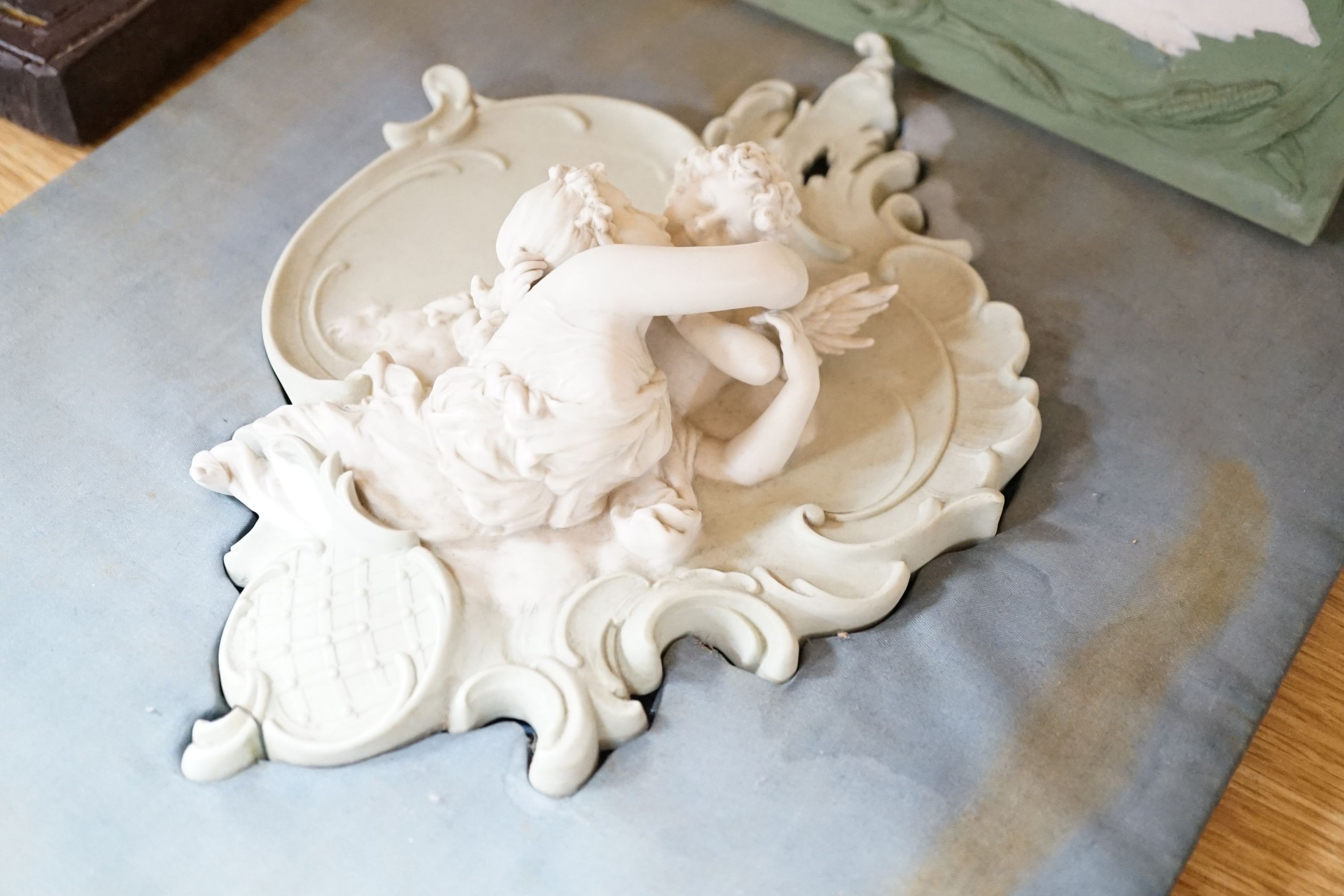 A collection of Limoges-type bisque plaques, largest 25.5 cm
